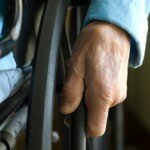 Elder hand on wheelchair